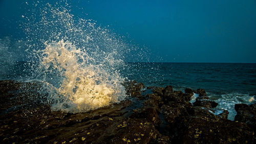 Sea waves splashing on rocks