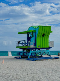 Lifeguard hut on beach against sky