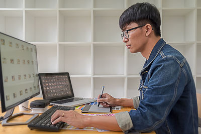 Side view of senior man using smart phone