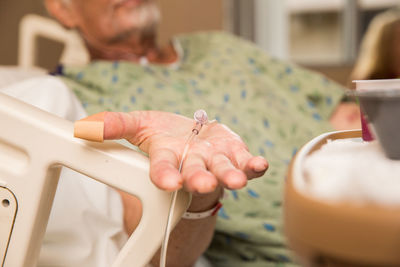 Midsection of senior patient gesturing in hospital 
