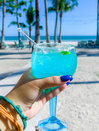 Close-up of hand holding blue drink