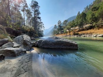 Scenic view of waterfall against sky