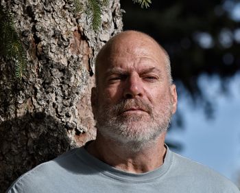 Portrait of man against trees