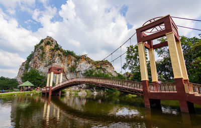 Arch bridge over river against sky