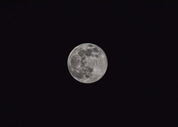 Low angle view of moon against clear sky at night