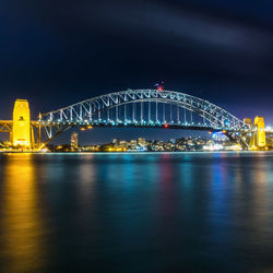 Illuminated sydney harbour bridge at night