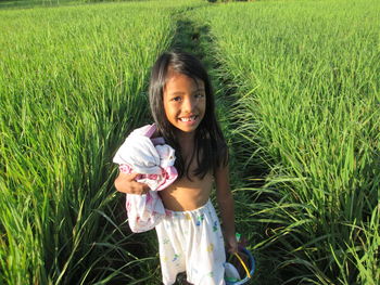 Portrait of smiling girl on field