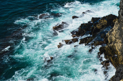 High angle view of rocks in sea