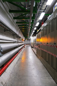 Illuminated underground walkway amidst buildings