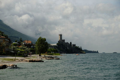 Panoramic view of sea and buildings against sky