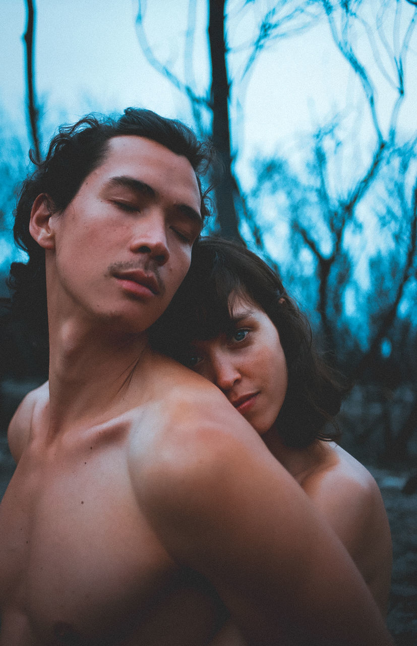 adult, two people, women, young adult, men, love, togetherness, portrait, emotion, tree, nature, positive emotion, person, romance, blue, female, embracing, lifestyles, human face, forest, plant, outdoors, photo shoot, waist up, headshot, barechested, affectionate, land, standing, bonding