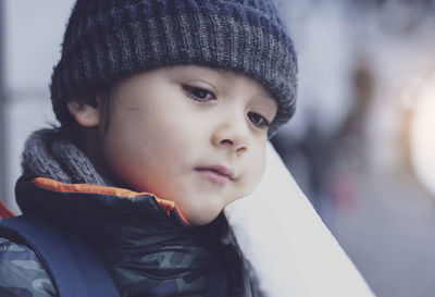 Close-up portrait of cute boy in winter