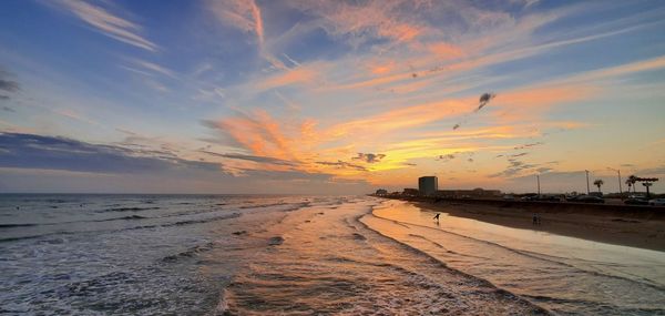 Scenic view of beach against sky during sunset