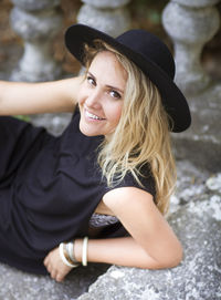 Portrait of beautiful young woman sitting in hat