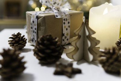 Ecologic packaging gift with pinecone and wooden christmas ornaments