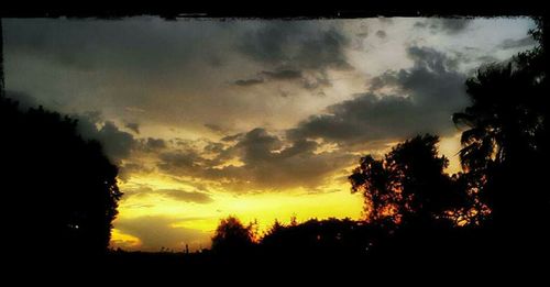Silhouette of landscape against cloudy sky
