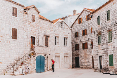 Rear view of people walking on building