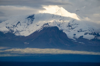 Aerial view of snowcapped mountains against sky