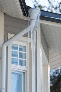 Low angle view of icicles on roof of building