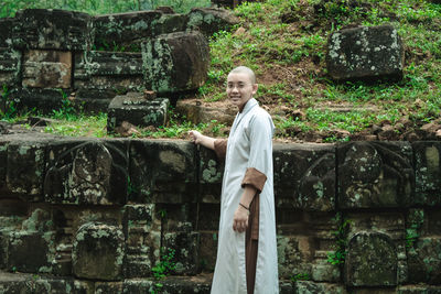 Portrait of man standing against wall