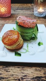 Close-up of burger and bread on table