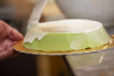 Close-up of hand holding ice cream