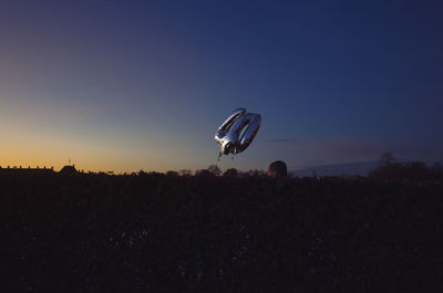 Silhouette of hot air balloon against clear sky