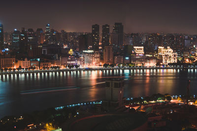 Illuminated city at waterfront