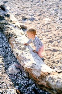 High angle view of boy on rock