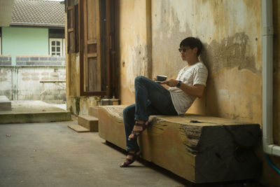 Side view of young woman using mobile phone