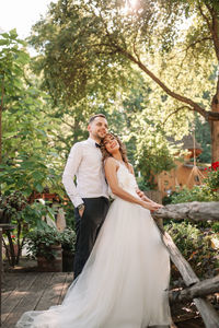 Smiling couple embracing while standing outdoors