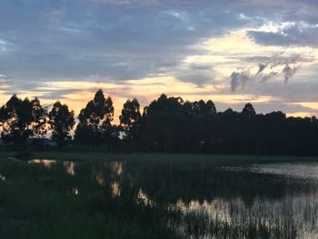 Scenic view of lake against sky during sunset