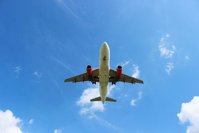 Low angle view of airplane flying in sky