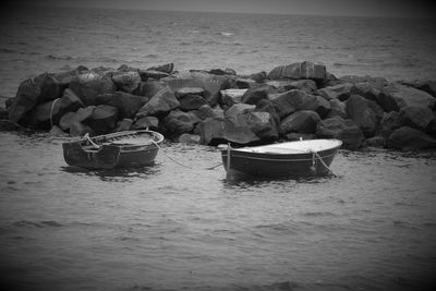 View of rocks on sea shore against sky