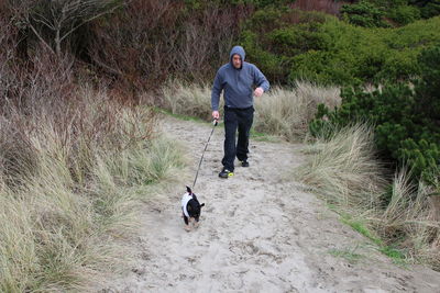 Full length of man with dog on street