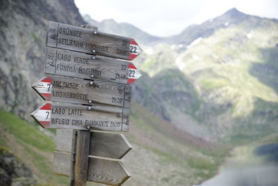 Information sign against mountain range