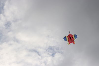 Low angle view of airplane flying against sky