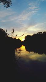 Scenic view of lake against sky at sunset