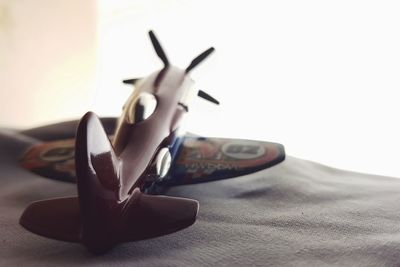 Close-up of airplane on table against white background