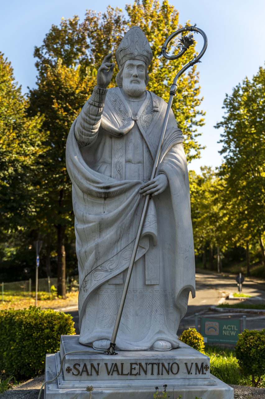 STATUE IN PARK AGAINST TREES