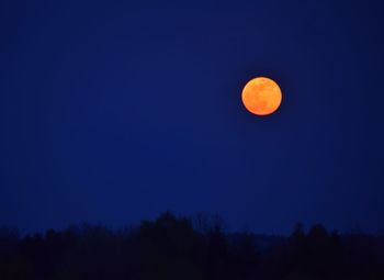 Scenic view of moon in blue sky at night