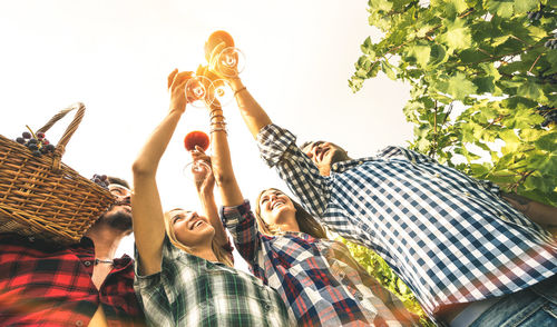 Low angle view of friends at vineyard