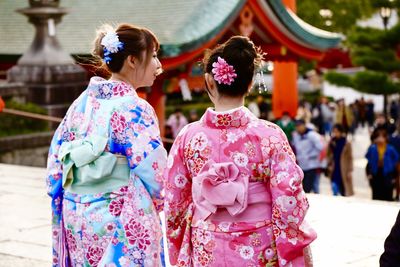 Rear view of women with flowers