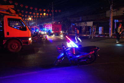 Vehicles on road in city at night