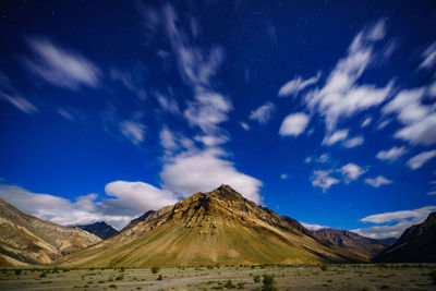 Scenic view of snowcapped mountains against blue sky