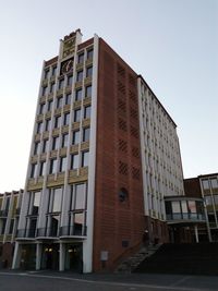 Low angle view of office building against clear sky