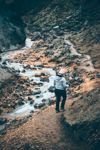 Rear view of man standing on rock