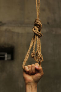 Close-up of human hand holding rope