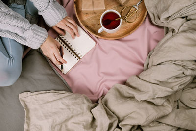 High angle view of woman relaxing on bed