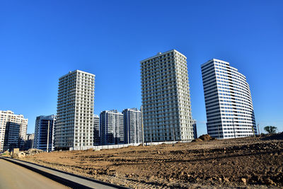 View of a large construction site with tall residential buildings and skyscrapers. 
